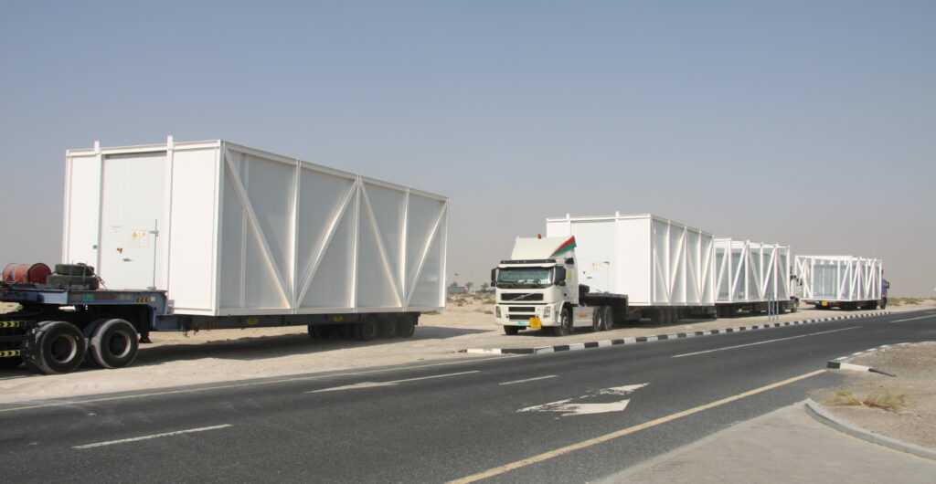Ice storage and water tanks in steel frames ready installed on trucks for transport to the construction site.